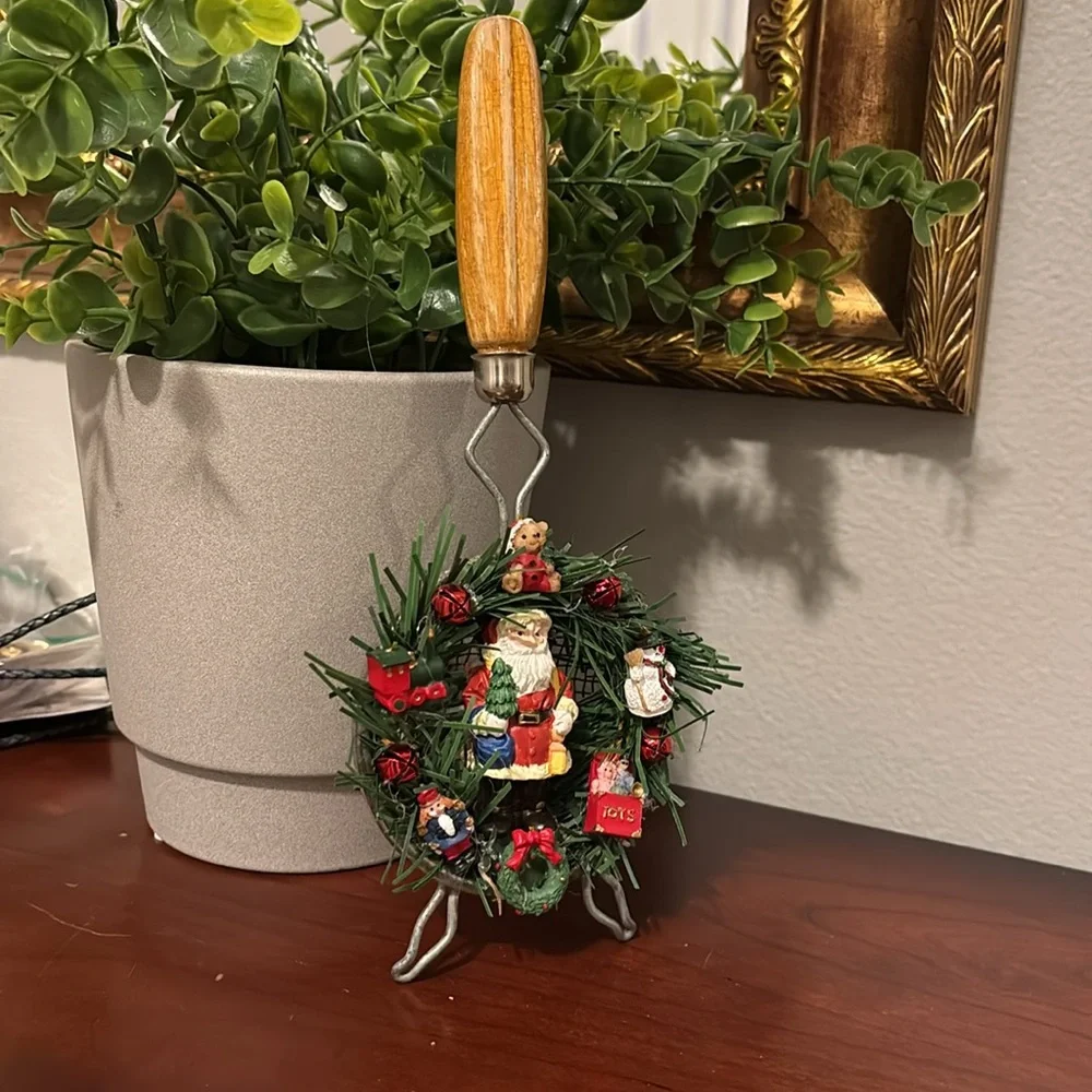 Handmade Santa Holiday Wreath on an old tea strainer.